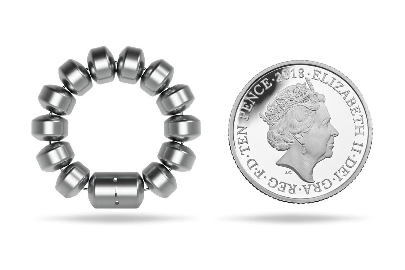 A LINX device for reflux alongside a 10p coin, showing their similar relative size